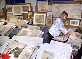 Ruth Buffington looks through illustrations at Frank Oppel's, Stamford, Conn., booth.