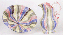 A large offering of spatter was sold This pitcher and bowl set in yellow green red black and blue sold at 25857