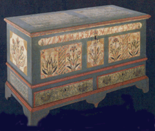 The LehighBerks County painted dower chest featured decoration on the front of the case as well as its sides and lid
