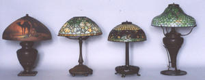 From left to right Handel Desert Scene lamp 23000 Tiffany Crocus lamp 21275 Tiffany Studios Pointsetta lamp 36800 and a Tiffany Studios lamp with Tyler Scroll design 13800