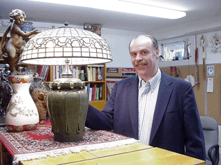 Auctioneer Robert L Foster and the prize lamp he believes is worth paying double the 41800 selling price for to keep in Maine
