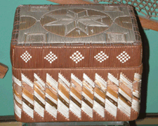 A powerful design incorporating an eightpointed star on the lid and lightning bolts around the sides distinguishes this exceptional polychrome quillwork box of the Nineteenth Century