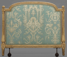 The complete alcove bed has a prime location in the exhibition This end view of the headboard shows post carvings and three decorative upholstery motifs Sea horses river gods and spaniels