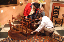 John Philbrick explains the finer points of a gateleg table to a client