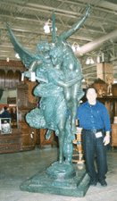 Dealer Edmondo Crimi stands next to a bronze garden sculpture Best of France Inc Lambertville NJ