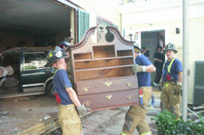 Firemen remove the remains of a circa 1780 highboy from the ButlerMcCook House SUV visible in the background The piece was the only known example of Colonial furniture in Hartford representing an unbroken chain of ownership never leaving its original residence until now