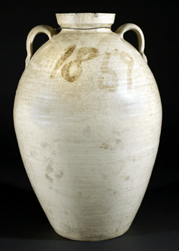 The lime-glazed jar was made in a lime glaze with an iron-bearing wash circa 1870. It is marked "MF” for the Masten Ussery Falkner potters.