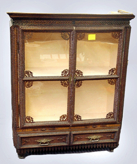 A diminutive two-door tramp art cupboard with two drawers went to $6,613. It came from the Wallach collection. 