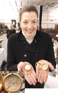 Cowan's decorative arts specialist Diane Wachs with the inscribed gold pocket watch that had been presented by Benjamin Franklin to his nephew, Jonathan Williams. Dated 1771 on the inscribed case, it sold for $34,500. The outer protective case retained the Nineteenth Century repair labels (detail). 