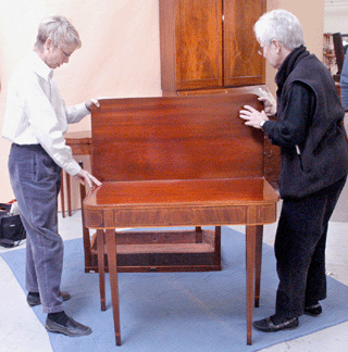 Looking over one of a pair of Baltimore card tables that sold for $12,760.