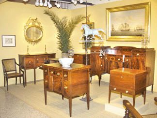 As the hometown specialist in Southern furniture, A. Fairfax Antiques of Charleston always sells well here. Center is a Charleston sideboard, possibly by James Main. A similar sideboard is illustrated in The Furniture of Charleston by Bivens and Rauschenberg.