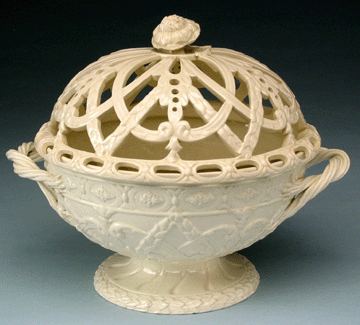 Open basketwork, symbolizing dessert, referred to the tradition of using woven baskets for harvesting and serving fruit. Josiah Wedgwood (1730‱795) and other potters imitated these earlier baskets in pierced creamware. Wedgwood's first creamware catalog issued in 1774 illustrated an orange basket. The form is still made at the modern factory. Orange or chestnut basket made by Wedgwood Factory (1759⁰resent), stamped "WEDGWOOD†and "O†on base, Etruria, Staffordshire, England, circa 1780. Historic Deerfield, museum purchase with funds provided by Ray J. and Anne K. Groves. 