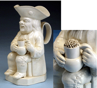 A whimsical favorite is this Toby jug, holding on his knee a foaming mug of ale. Toby jugs were first made in an area called The Potteries in Staffordshire, England, in the latter half of the Eighteenth Century for pouring ale in taverns and middle-class homes. The term Toby probably comes from Toby Philpot, the nickname of Harry Elwes, whose fondness for alcohol was celebrated in the song "The Brown Jug,†published in 1761. The potter stippled the clay on the mug to simulate the effervescent froth. Lead-glazed creamware, Staffordshire or Yorkshire, England, circa 1800. Historic Deerfield, museum purchase with funds provided by Ray J. and Anne K. Groves. 