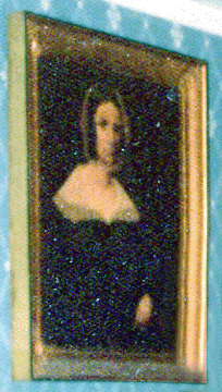 The three-quarter-length folk art portrait of a woman in a gold frame measures approximately 3 feet by 3 feet. The painting is rather dark and the details are difficult to make out. The sitter wears a white mopcap with a ribbon, and her dress has a white "lace†fabric that covers her shoulders and top of the dress at the bodice. The woman's hair is parted in the middle and appears to be brown with ringlets on either side of her face. Her left hand is visible in her lap.