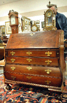 A Massachusetts bombe mahogany slant front desk with replaced feet sold for $15,525.