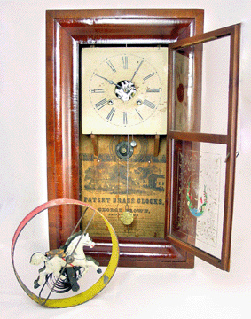 George W. Brown was the connection between clocks and clockwork toys. Shown here, a clock from circa 1855 and a horse in hoop, circa 1865.