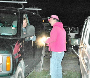 Greg Baecker greets longtime vendor Karen Marquis as he collects $40 from vendors for a single space.