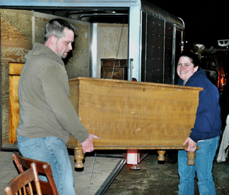 Nicholas and Susan Richey, Port Jefferson, N.Y., unload a grain painted blanket box.
