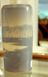 A signed Rookwood vase was decorated with a landscape beneath a vellum glaze and sold for $1,495.