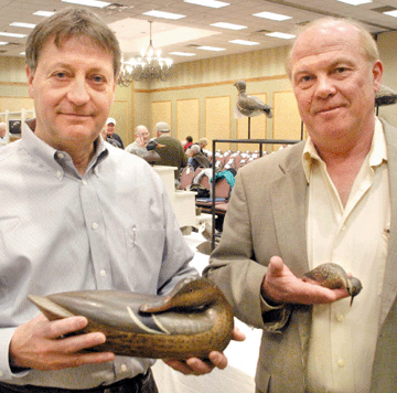 Frank Schmidt and Gary Guyette prior to the auction with the Charles Perdew sleeping mallard hen and the Elmer Crowell plover. The decoys realized $252,500 and $214,000, respectively.