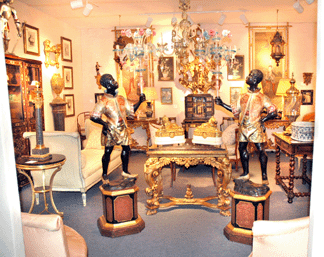 The pair of mid-Nineteenth Century Venetian lacquered and parcel gilt blackamoors holding Murano glass chandeliers at the entrance of Parisian dealer Galerie Sylvain Lévy Alban attracted enormous interest. The gallery owner said a client wants them to go on approval.