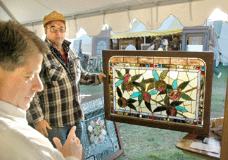 Fritz Sterbak of Investment Antiques & Collectibles, Havre de Grace, Md., shows a Philadelphia window, circa 1880, in its best light for a customer. ⁔he Meadows.