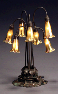 A Tiffany Studios Favrile glass and bronze seven-light "Lily†lamp, circa 1910, sold above estimate at $24,675.
