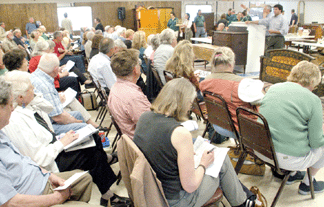 Ron Bourgeault and Peter Coccoluto work the standing-room-only crowd.