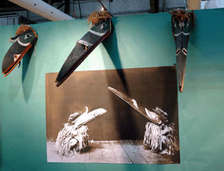 Three Northwest Coast Kwakiutl masks of the Hamatsa society were displayed above a photograph by Edward Curtis that had appeared in his volume on the Kwakiutl Indians. All three masks sold at Myers & Duncan, New York City.