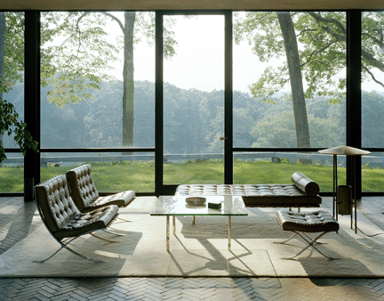 The simplicity of Mies van der Rohe's classic furniture provides a certain sense of serenity, as though the human hand dared not impose too heavily on the landscape. An area rug placed atop the brick floor draws the setting together. The tabletop items remain in the places that Johnson divined for them.