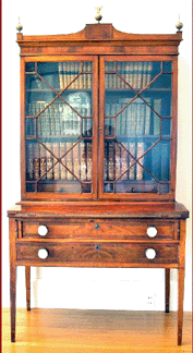 A Federal mahogany secretary with inlay and astral glazed doors over two drawers descended in the Lamont family and went to a Connecticut collector for $7,590. 
