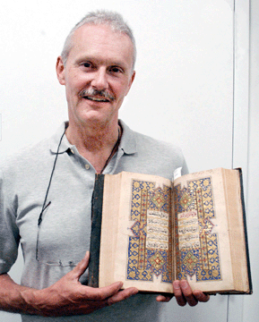 Auctioneer William Jenack with the Sixteenth or Seventeenth Century Persian Koran that sold for $5,750.