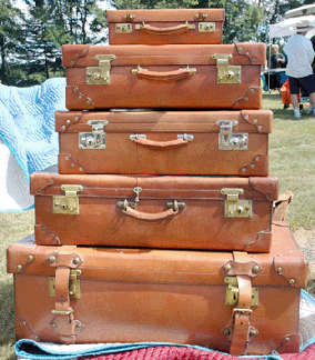 A set of five English suitcases, saddle leather, in great condition made for a pleasing vignette at Jack Pap Antiques, Simsbury, Conn. ⁍ay's Antique Market