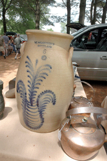 Samuel Herrup, Sheffield, Mass., brought this stoneware churn with stylized floral design made by Woodruff, Cortland, N.Y., circa 1860. ⁈ertan's Antique Market