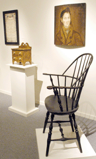 A shapely Windsor armchair is among the furniture displayed.