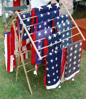A vibrant display of American flags on an antique drying rack was shown by R&R Collectibles of Easthampton, Mass. The booth was filled with mantel and wall clocks and even more flags.