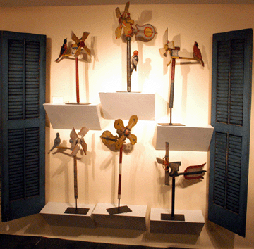 A collection of folky carved and painted whirligigs by Albert Ferinand Beversdorf, Chicago, sold during preview from the booth of Carlson and Stevenson, Manchester Center, Vt.