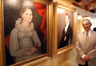Stuart Feld of Hirschl & Adler Galleries with a pair of Ammi Phillips portraits of John and Blithia Haskell, circa 1820.