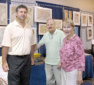 Show manager Arlene Shea and show producer Gary Gipstein talk with exhibitor Vinny Caravella, center, of The Scrapbook, Essex, Mass. Caravella has been a regular at Papermania Plus since its founding in the 1970s.