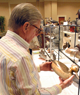 A collector looks over the Ira Hudson merganser hen that sold for $214,000.