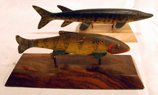 The Lake Chautauqua yellow perch fishing decoy, foreground, sold for $11,500, while the musky spearing decoy brought $34,500.