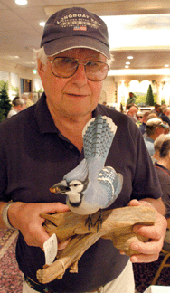 Cape dealer and collector Charles Adams was pleased with his purchase, a life-size blue jay by Massachusetts carver Arnold Melbye that sold for $7,762.