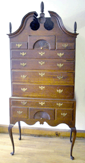 A Connecticut Queen Anne cherry bonnet top highboy with pleasing proportions of 34 7/8 inches for the top, 37½ inches for the base and a height of 84 inches, with a full sunburst carved below the center finial and two fan-carved drawers, was purchased for $132,000 by Yardley, Penn., dealer C.L. Prickett.