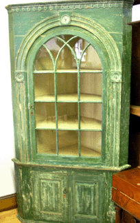 A rare Pennsylvania corner cupboard, circa 1780, in original paint went out at $9,900.