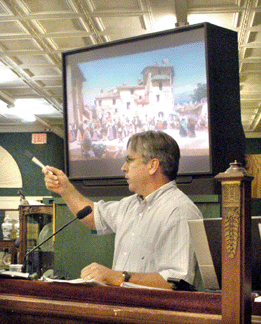 Auctioneer John McInnis looks to the telephones while selling the Barbason painting for $184,000.