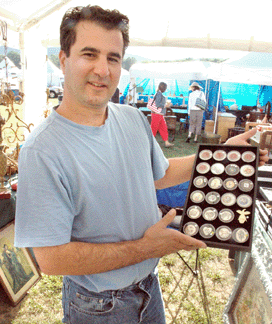 Tony Ciffone of Heavens to Betsy Antiques, Clinton, Tenn., displays some of his and wife Betsy's collection of rare buttons.