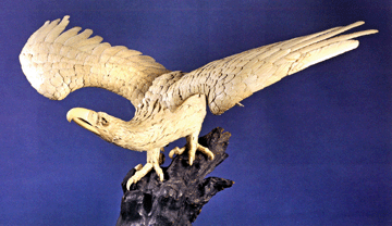 Far exceeding its $40/60,000 estimate, this Japanese carved and incised ivory eagle with talons grasping a tree branch, wing span 42 inches, sold for $369,000.