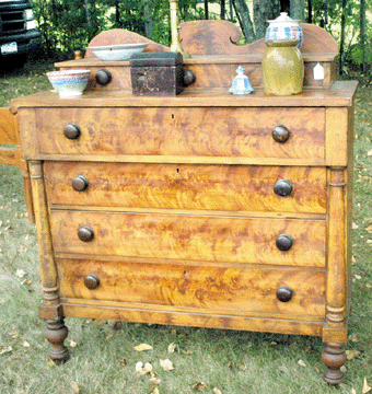 Bill Kelly, Limington, Maine, specializes in early American furniture, such as this grain painted five-drawer Empire chest, circa 1820″0, "guaranteed to brighten up any room.†⁍ay's Antiques Market