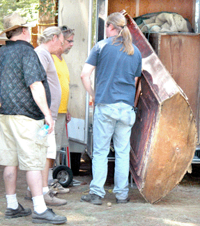 Clay Benson, Ontario, Canada, entices a crowd before the bell by partially pulling out his best piece, a barrel back Connecticut cupboard. ⁈ertan's Antique Market