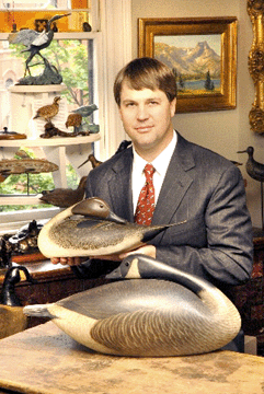 Stephen B. O'Brien Jr with antique preening pintail drake and sleeping Canada goose decoys by renowned carver A. Elmer Crowell.